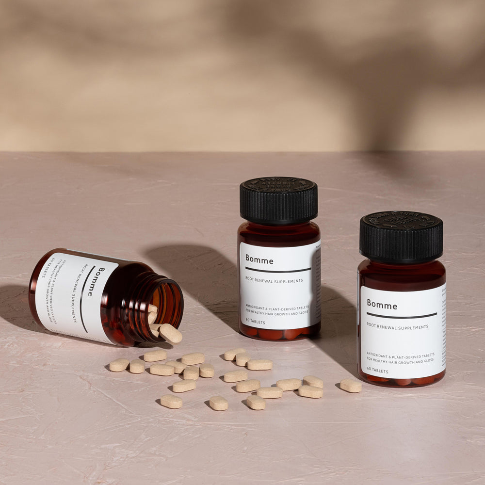 Three bottles of Bomme Root Renewal Supplements shown together, representing a 3-month supply with minimalist amber glass packaging.