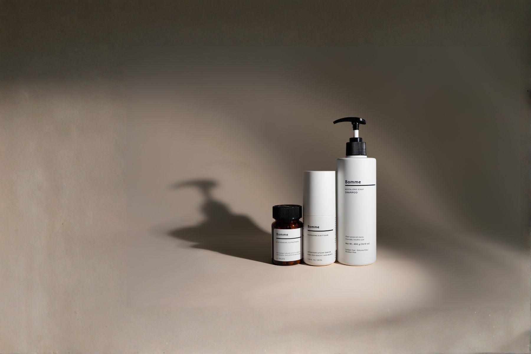Bomme Ritual products, Shampoo, Toner, and Supplements, on a neutral background