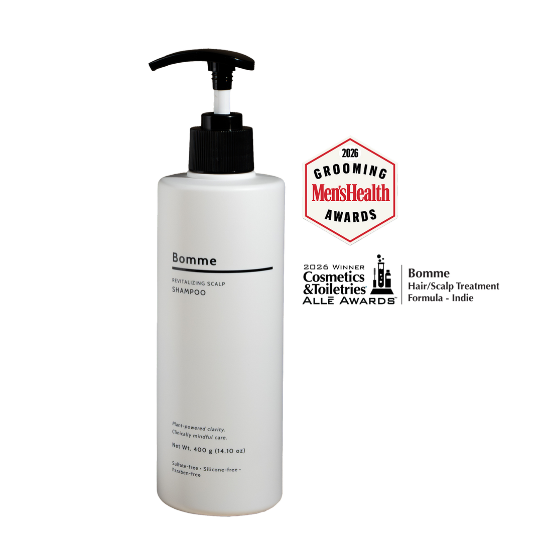 Bottle of Bomme hair/scalp treatment with awards on a white background