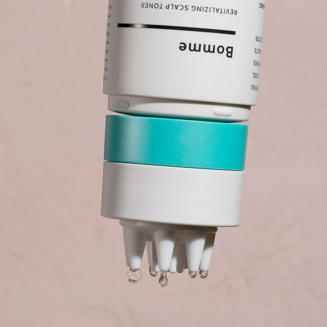 Close-up of white silicone scalp applicator tip on Bomme Toner bottle, designed for targeted scalp application.