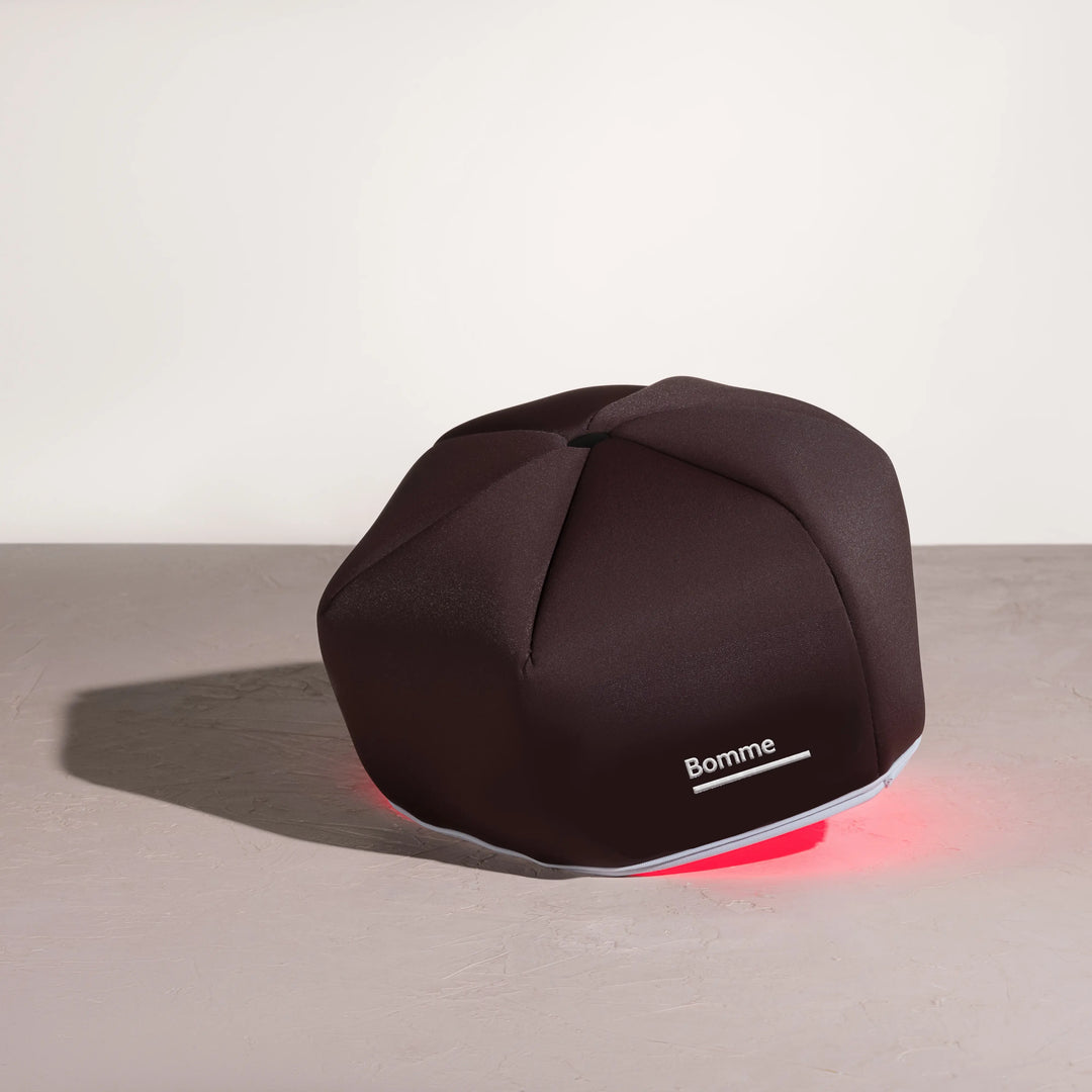 Bomme LED Red Light Device with the red lights on in a neutral background.
